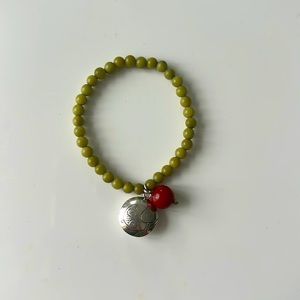 Green bracelet with silver fish embellished bracelet